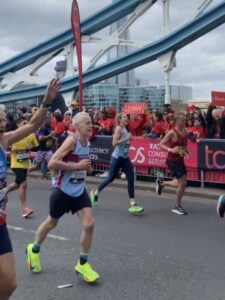 Chris Raby running across Tower Bridge at the 2024 London Marathon