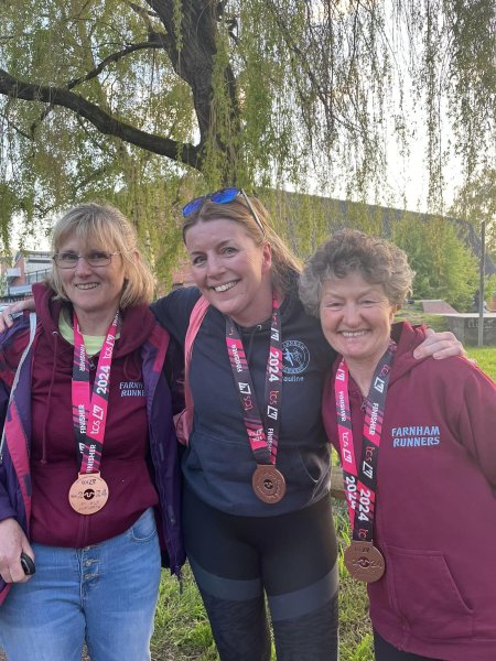Julia Tagg, Pauline Hamilton, and Linda Tyler with their medals back in Farnham after the 2024 London Marathon